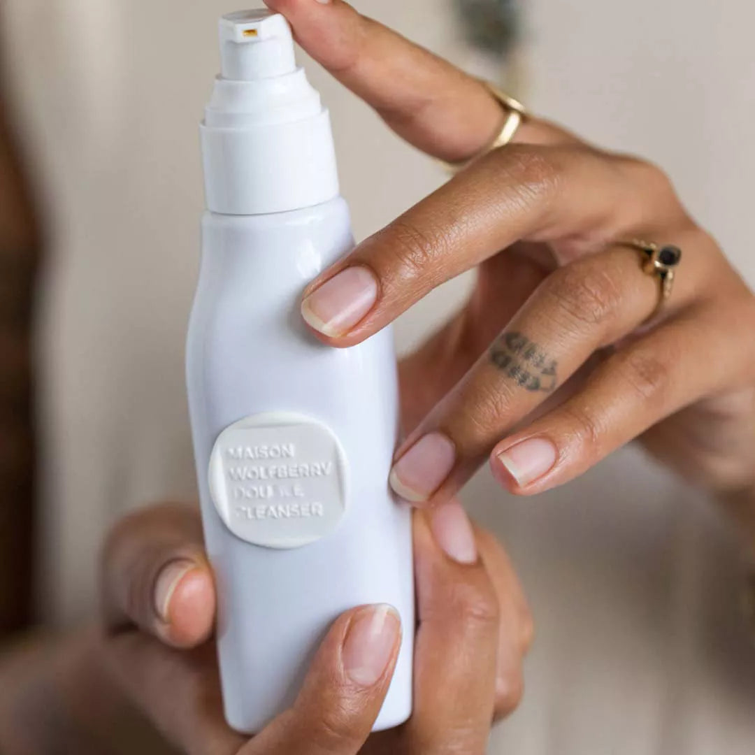 Hands holding Double Cleanser bottle