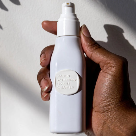 Double Cleanser bottle held in hand
