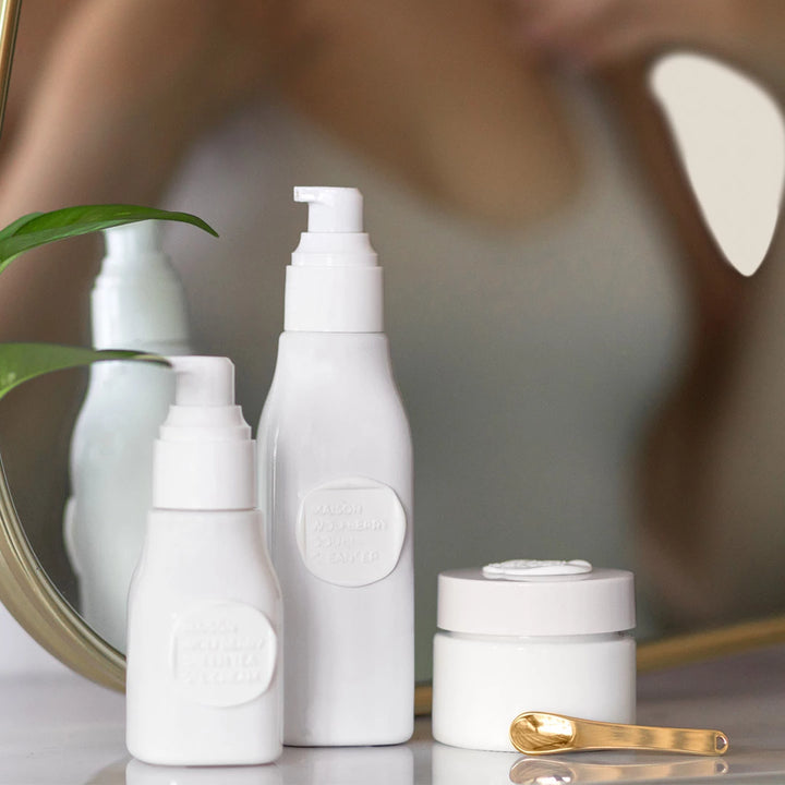 Skincare set bottles in front of a mirror