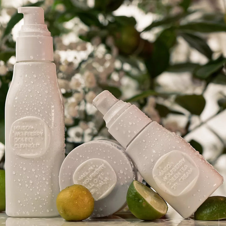Skincare set bottles, with citrus fruit and leaves in the background